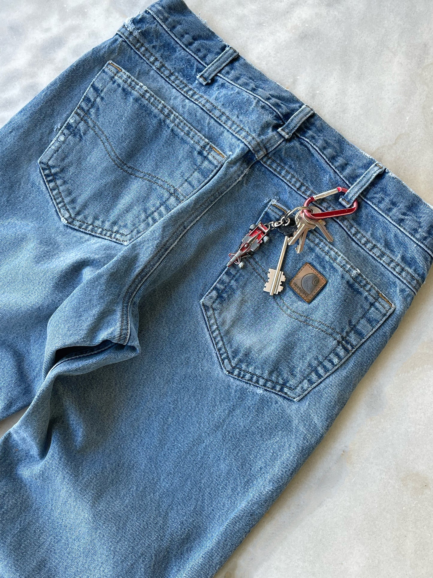 CARHARTT DISTRESSED DENIM PANTS WITH CUTS